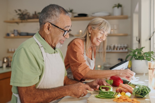 A couple cooking a meal together.