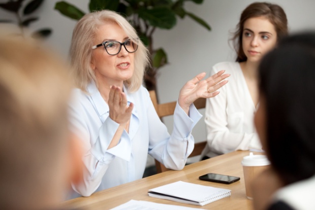 A woman talking during a work meeting.