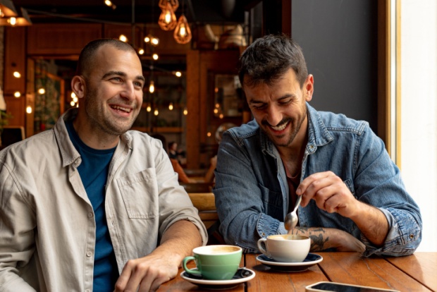 Two men talking in a café.
