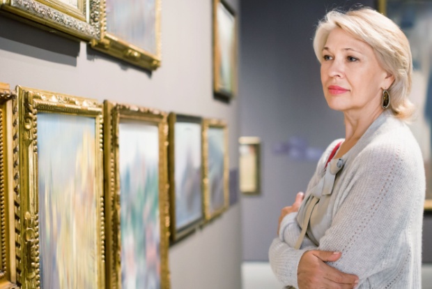 A woman looking at art in a gallery.