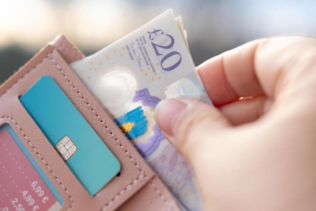 Someone taking money out of a wallet.