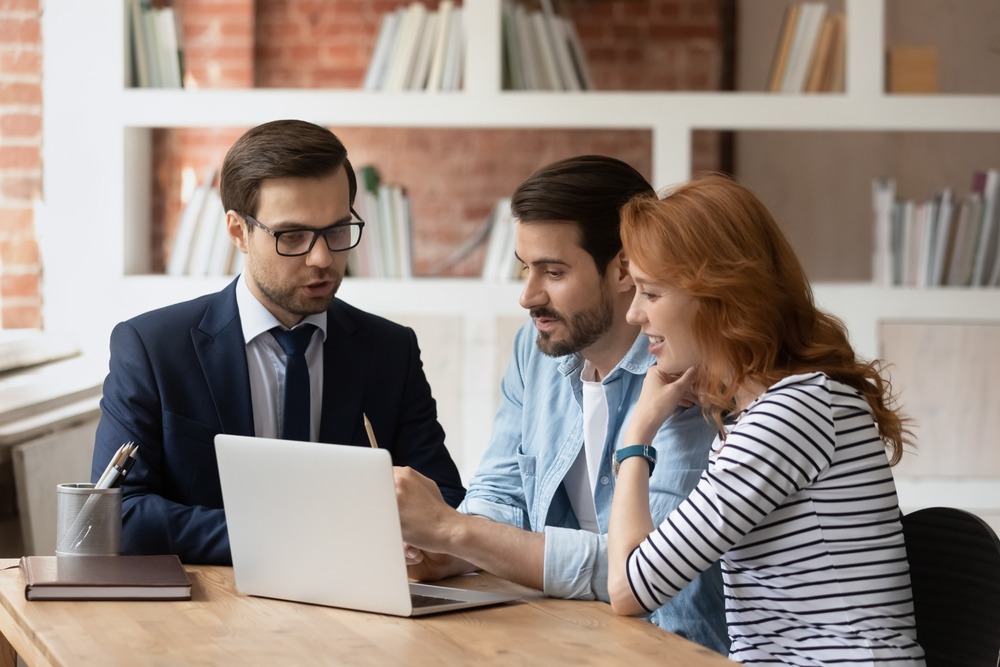 A couple speaking to a mortgage adviser.